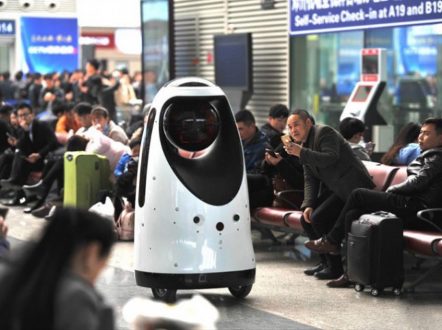The robot police officer patrols one of Chinese railway stations
